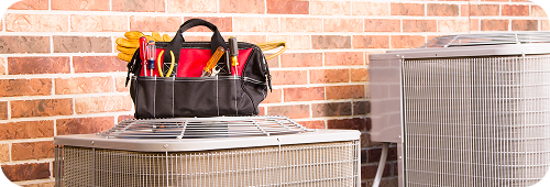 Tool bag sitting on top of AC unit