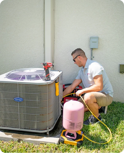 Technician doing maintenance on AC unit