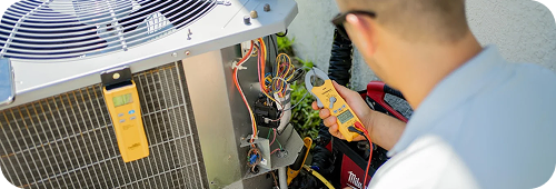 Technician working on AC maintenance